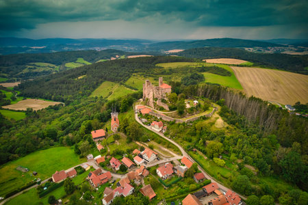 A stunning aerial capture of a historic castle nestled elegantly amidst lush green fields and picturesque scenery. Hanstein castle, Germany.の写真素材