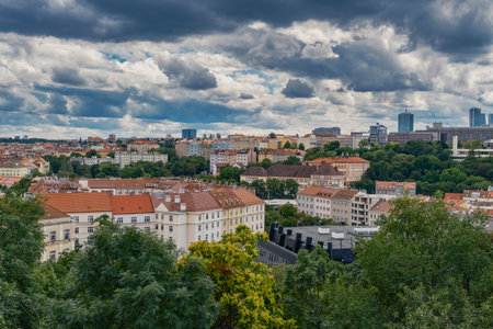 Breathtaking panoramic view of Prague, showcasing its historic city center with iconic buildings, charming red-roofed houses.の写真素材