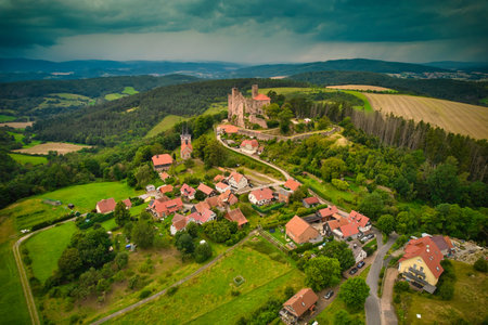 A stunning aerial capture of a historic castle nestled elegantly amidst lush green fields and picturesque scenery. Hanstein castle, Germany.の写真素材