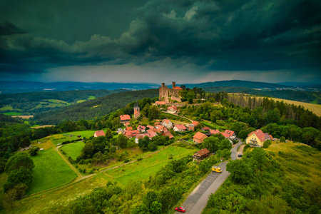 A stunning aerial capture of a historic castle nestled elegantly amidst lush green fields and picturesque scenery. Hanstein castle, Germany.の写真素材