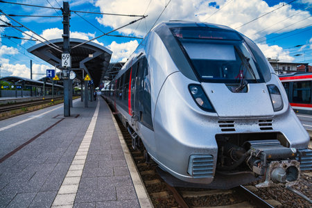 Refined locomotive at platform, contemporary transportation scene with passengers and signage presentの写真素材