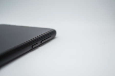 Smartphone on a white background, the smartphone lies sideways visible only buttons.の写真素材