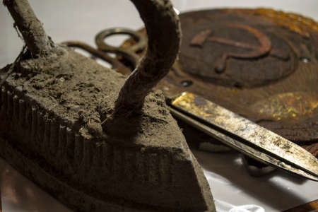 Big old sweaty scissors and an antique iron that was heated on the stove.の写真素材