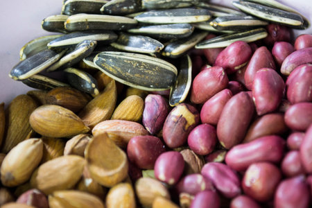 A mixture of different types of nuts and seeds. Ground nuts, almonds, seeds.の写真素材