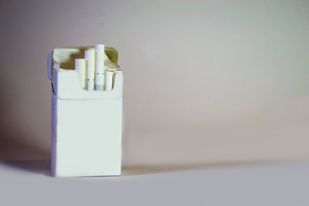A pack of cigarettes on a light gray background. Loneliness.の写真素材