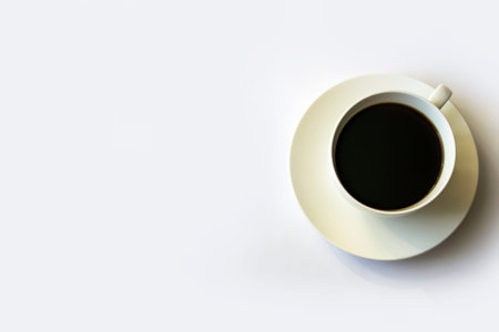Morning coffee in a white cup on a white saucer.
