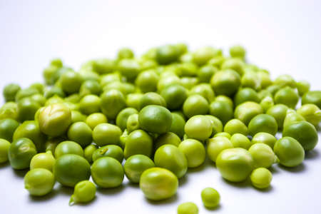 Scattered peas on a white background, Screensaver or article about the benefits of green peas in the human diet.の写真素材