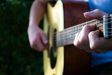 Learning to play the guitar. Interesting hobby or professional occupation of music. Music education or extracurricular activities or pastimeの写真素材
