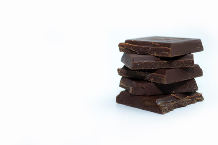 Black chocolate isolate on a white background, vertical frame format