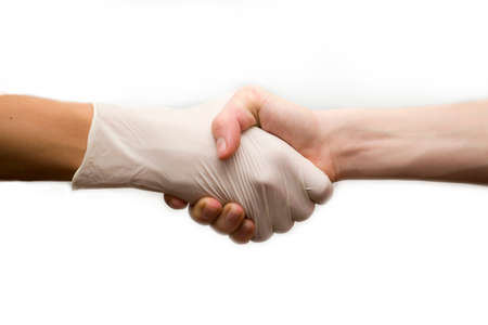A doctor shake hands with a patient on a white background.の写真素材