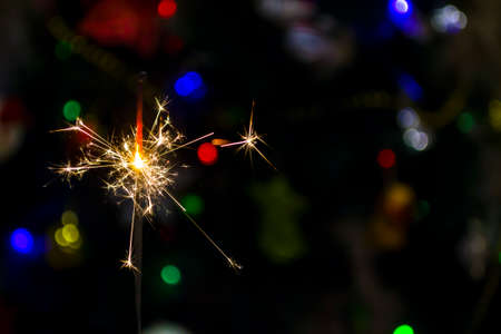 Sparkler on a colorful color background. Happy New Year. Close-up.の写真素材