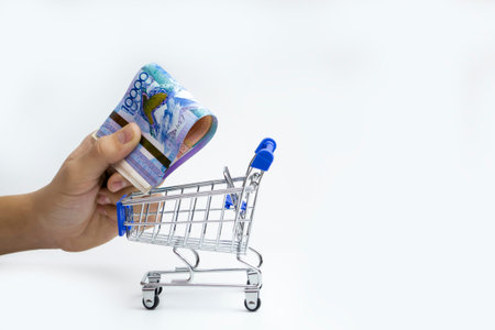 Tenge. Kazakh money in shopping cart on white background close-up.