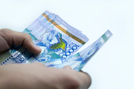 Tenge in the hands of a person, recalculation of funds.の写真素材