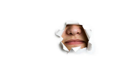 protruding nose through the hole in the paperの写真素材