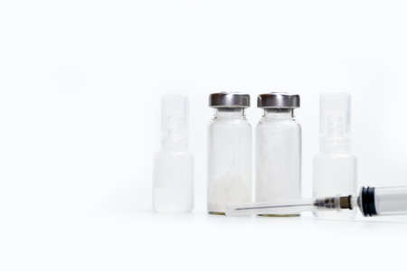 Vaccine bottles and syringes isolated on white background with space for text. Vaccination concept.の写真素材