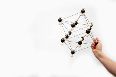 A molecule on a white background in the girls hand.の写真素材