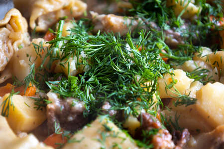 Stewed potatoes with meat and herbs.の写真素材