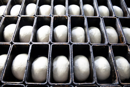 Laying the dough in the molds for future bread.
