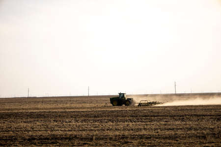 Tractor plowing fields -preparing land for sowingの写真素材