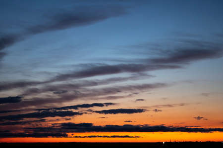 The sky in the evening has some parts of orange, reflecting light from the sun.の写真素材