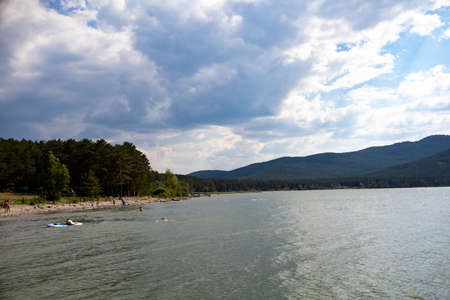 Lake and in the background is a mountain. Beach for relaxation in a mountainous area.の写真素材