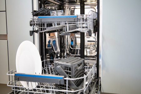 Built-in dishwasher in the kitchen, washing dishes. Plates, cups, glasses are worth washing....