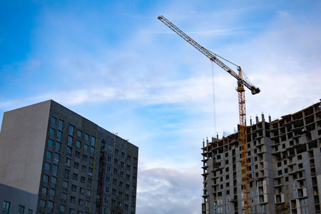 Inside place for many tall buildings under construction and cranes under a blue sky. High quality...
