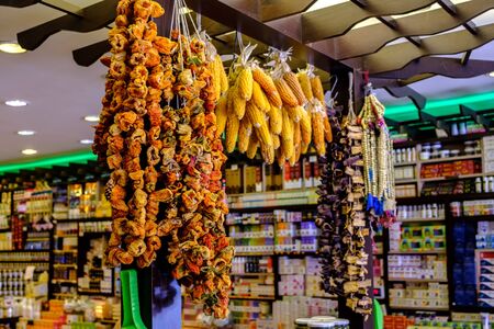 May 26, 2018, Erzurum, Turkey: Bundles of dried paprika, corn and eggplant in a store selling local spices.の写真素材