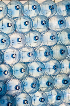 Empty PET bottles for drinking water 5 gallons (18.9 liters), stacked, vertical.