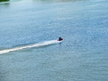 Man rides the scooter on a river