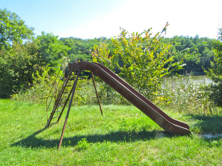 Old iron slider on playgroundの写真素材