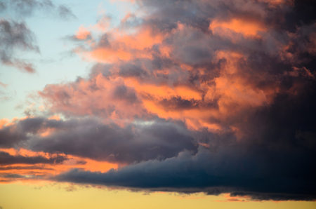 Beautiful bright sunset sky with the fluffy cloudsの写真素材
