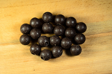 Chocolate balls lying on a wooden tableの写真素材