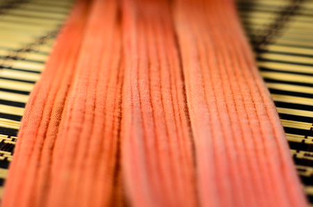 Martial arts orange belt on a bamboo matの写真素材