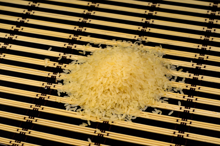 Pile of the long steamed rice on a bamboo matの写真素材