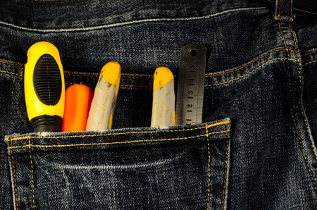 Pliers and screwdrivers in a pocket of the blue jeansの写真素材