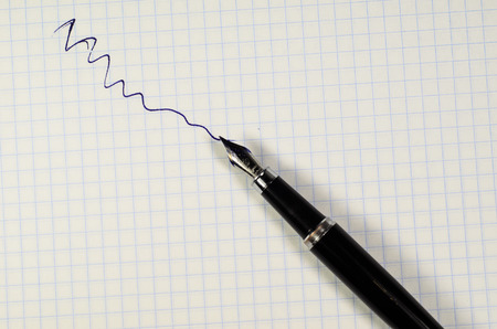 Fountain pen on a sheet of paperの写真素材