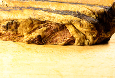 Smoked bacon on a wooden kitchen boardの写真素材