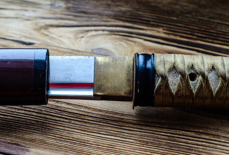 Japanese sword katana on a wooden backgroundの写真素材