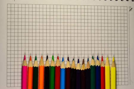 Colour pencils on a blank sheet of paper. Top viewの写真素材