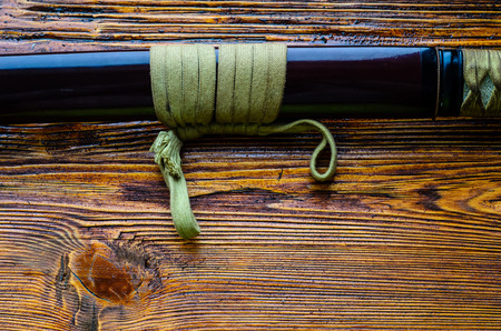 Japanese sword katana on a wooden backgroundの写真素材
