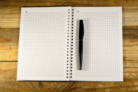 Notebook with the fountain pen on a wooden tableの写真素材
