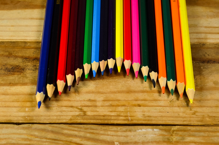 Colour pencils on a wooden table. Top viewの写真素材