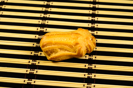 Tasty eclair cake on a bamboo matの写真素材
