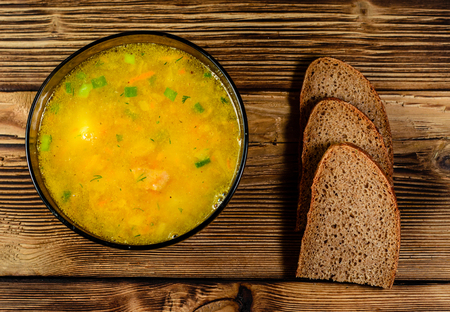 Vegetable soup in glass bowl on wooden table. Top viewの写真素材