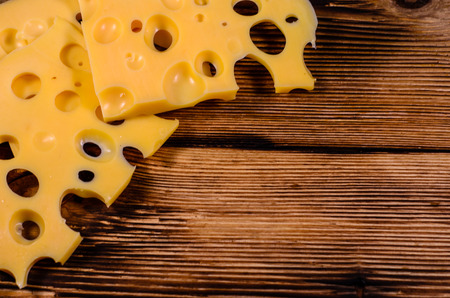 Sliced cheese on rustic wooden table. Top viewの写真素材