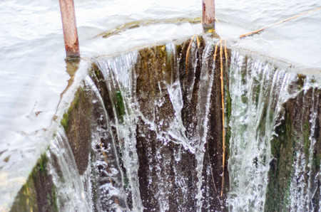 Water flowing from a dam on lakeの写真素材