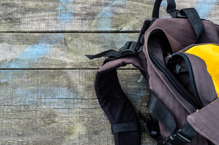 Touristic backpack on the rustic wooden table. Top viewの写真素材