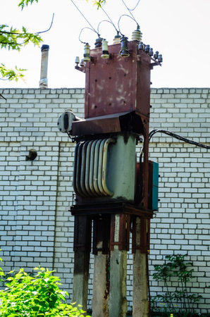 Old transformer on a concrete supports in a street
