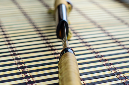 Japanese sword katana on a bamboo mat. Selective focusの写真素材